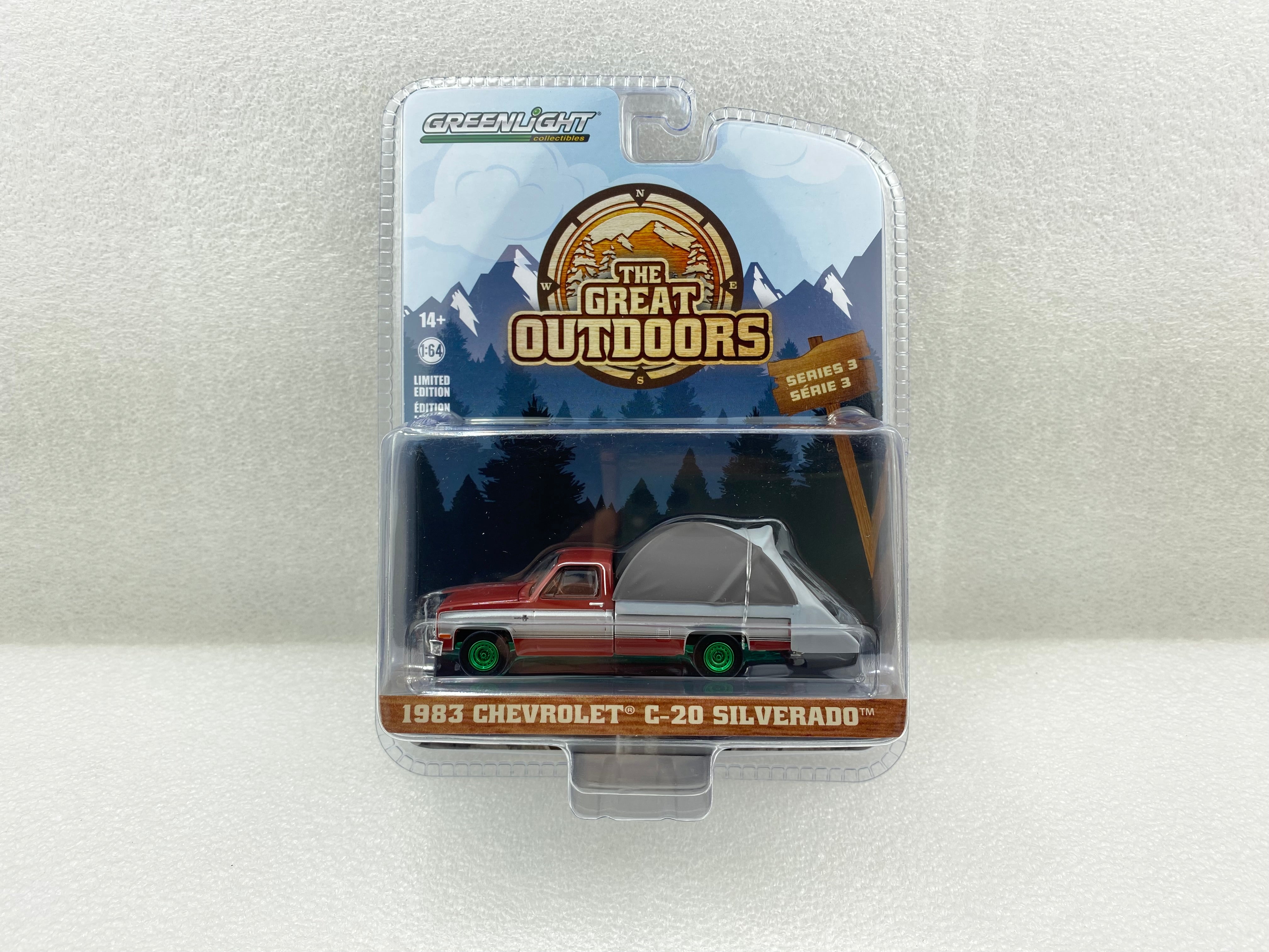 GreenLight Green Machine 1:64 The Great Outdoors Series 3 - 1983 Chevrolet  C20 Silverado - Carmine Red and Silver Metallic with Modern Truck Bed Tent 